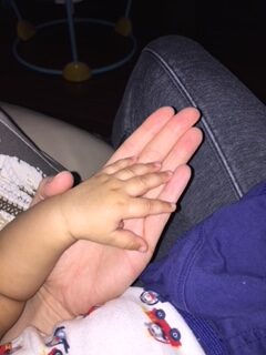 baby's hand laid on mom's hand